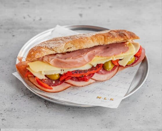 MLK Deli Deli Sando stacked with halal cold cuts and cheeses